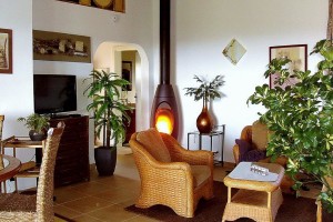 09 CASA PAVÃO - Living room with fire place (apart from central heating), bathroom door seen in the back