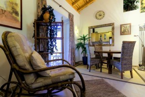 12 CASA PAVÃO - Living room with dining area and hatch to the kitchen, leftside terrace door to the conservatory